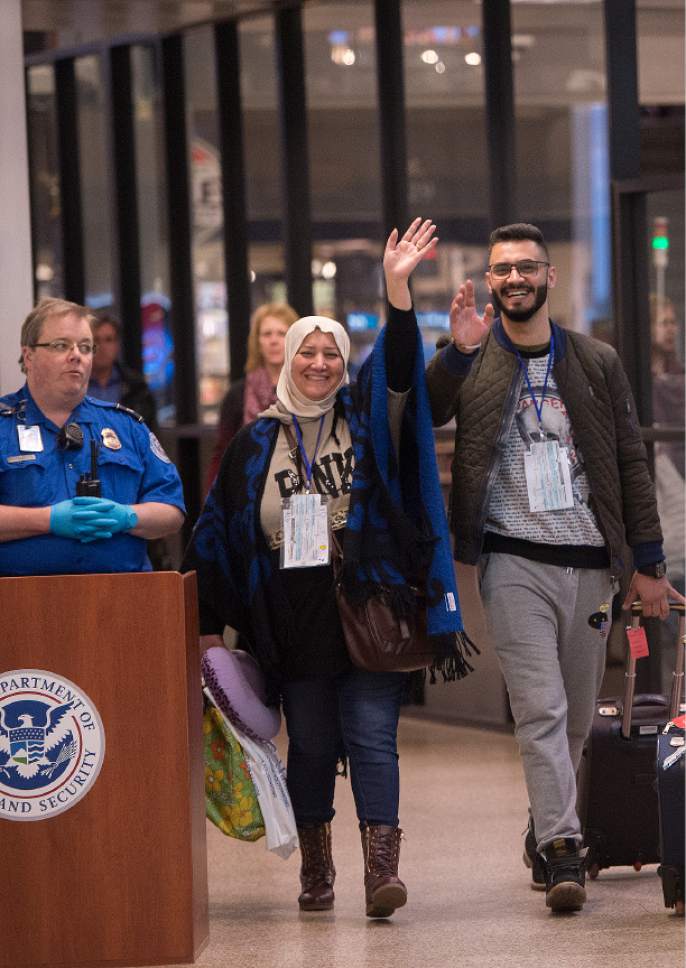 Leah Hogsten  |  The Salt Lake Tribune
l-r  Nisreen Alsaadi and her son Zaid Alsaadi wave at Iraqi family members after their arrival February 8, 2017 at Salt Lake International Airport. The Alsaadi's were allowed to come to the U.S. after a judge on Friday temporarily blocked President Donald Trump's ban on people from seven predominantly Muslim countries from entering the United States.