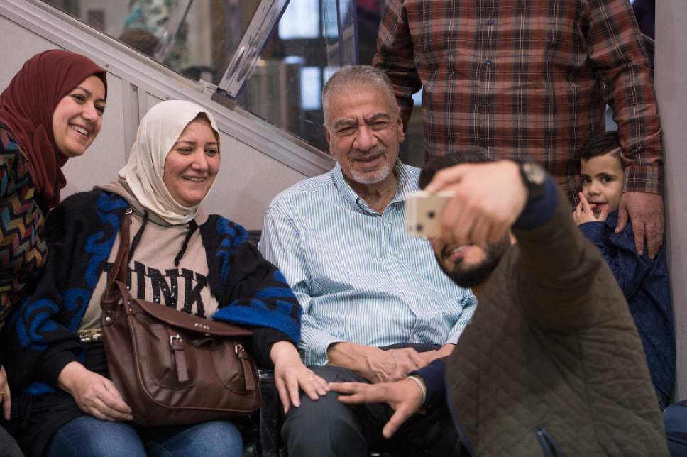 Leah Hogsten  |  The Salt Lake Tribune
l-r The Alsaadi family takes photographs of the arrival of Nisreen Alsaadi and her son Zaid Alsaadi at Salt Lake International Airport, February 8, 2017. The Alsaadi's were allowed to come to the U.S. after a judge on Friday temporarily blocked President Donald Trump's ban on people from seven predominantly Muslim countries from entering the United States.