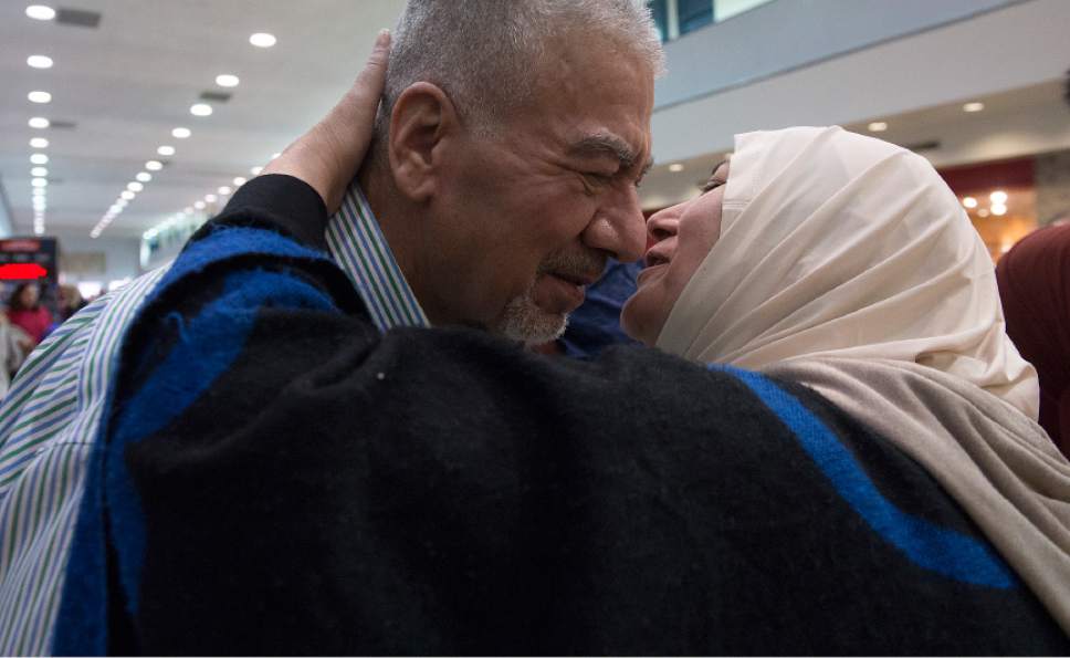 Leah Hogsten  |  The Salt Lake Tribune
l-r Nisreen Alsaadi kisses her brother, Qays Eabd Aljalil  upon seeing each other for the first time in several years at the Salt Lake International Airport, February 8, 2017. Nisreen Alsaadi and her son Zaid Alsaadi were allowed to come to the U.S. after a judge on Friday temporarily blocked President Donald Trump's ban on people from seven predominantly Muslim countries from entering the United States.