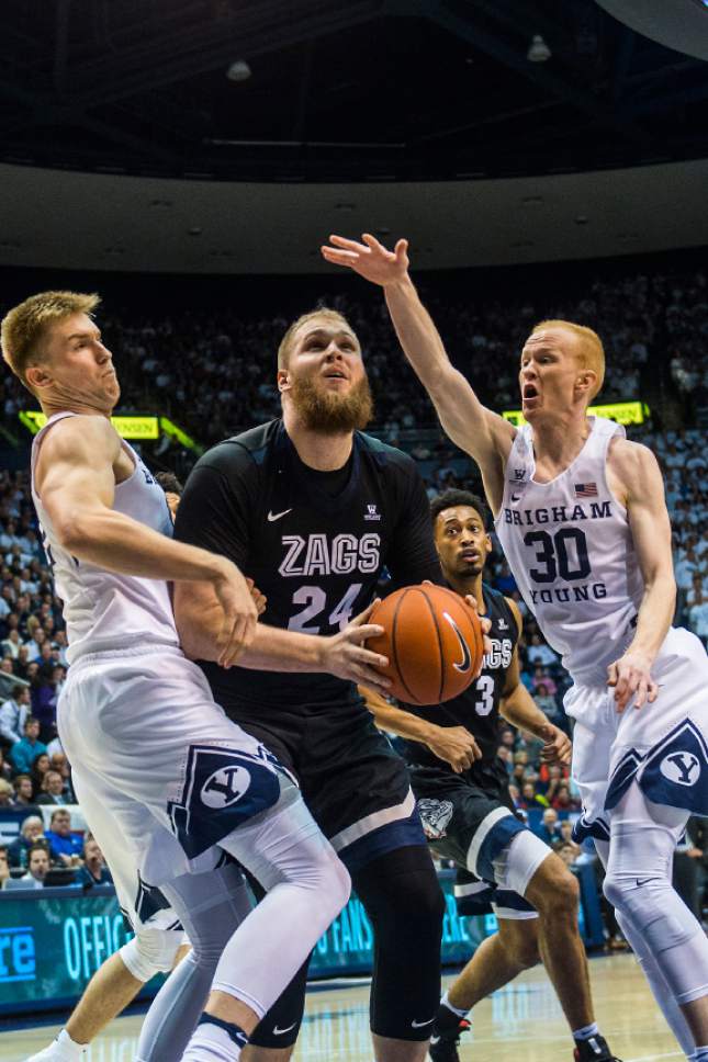 Chris Detrick  |  The Salt Lake Tribune
Brigham Young Cougars forward Eric Mika (12) and Brigham Young Cougars guard TJ Haws (30) guard Gonzaga Bulldogs center Przemek Karnowski (24) during the game at the Marriott Center Thursday February 2, 2017.