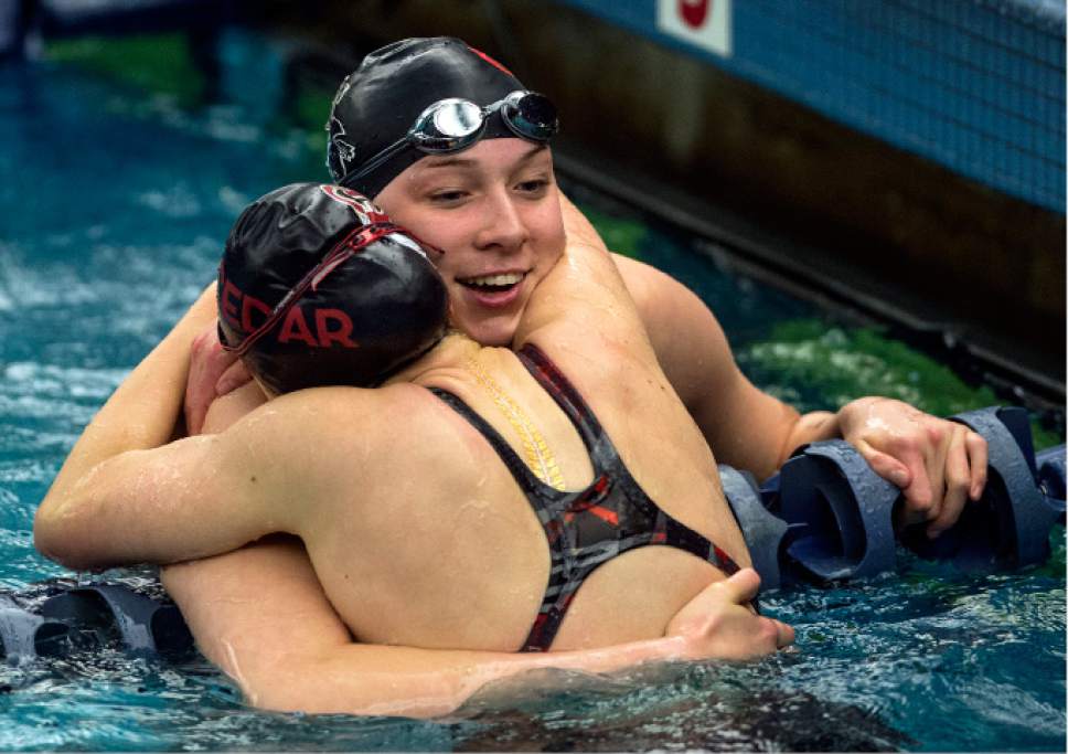 Steve Griffin  |  The Salt Lake Tribune


Kristen Gross, of Cedar City, gets a big hug from teammate Aspen Bonzo at the finish of the 50 free during the first day of the state 3A swimming championships at the BYU natatorium in Provo Friday February 10, 2017. Hess won the event. Selznick won the 50 free finals.