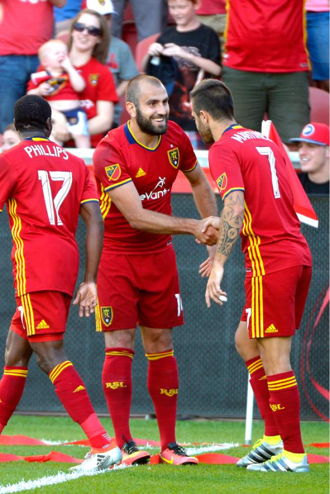 Leah Hogsten  |  The Salt Lake Tribune
Real Salt Lake forward Yura Movsisyan (14) scores in the first half and celebrates with the team with a handshake. Real Salt Lake is tied 1-1with the Colorado Rapids during their Rocky Mountain Championship Cup game at Rio Tinto Stadium Friday, August 26, 2016.