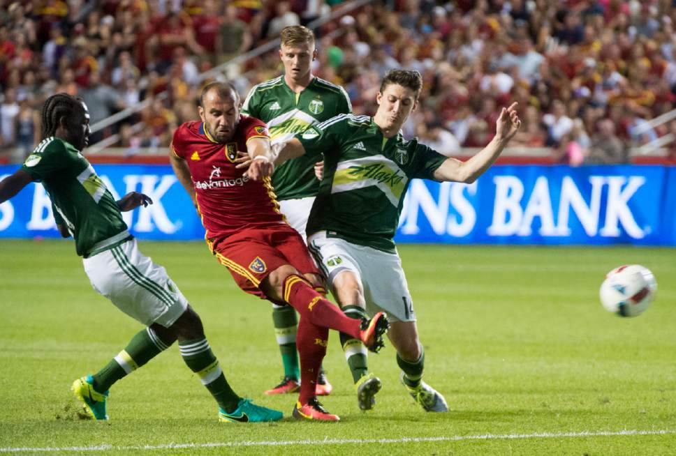 Rick Egan  |  The Salt Lake Tribune

Real Salt Lake forward Yura Movsisyan (14) gets a kick, as Portland Timbers midfielder Diego Chara (21) and Portland Timbers midfielder Ben Zemanski (14) defend, in MLS soccer action, Real Salt Lake vs. Portland Timbers, in Sandy, Friday, June 18, 2016.