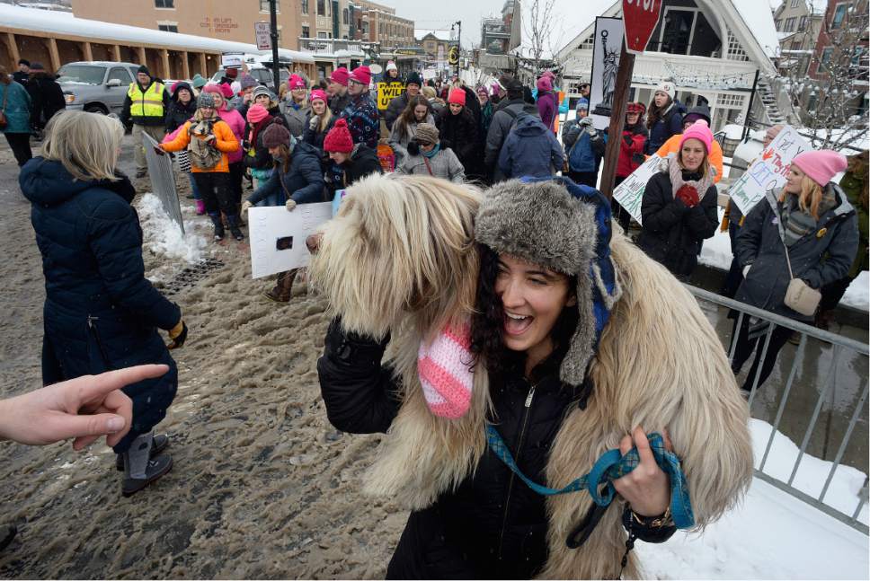 Scott Sommerdorf   |  The Salt Lake Tribune  
Carley Major held her dog "Kovu" as a furry scarf during the end of he Women's March down Main Street in Park City, Saturday, January 21, 2017.