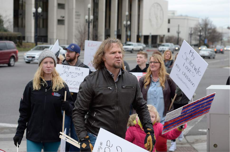 Scott Sommerdorf   |  The Salt Lake Tribune  
Polygamist Kody Brown and his family marched across State Street near the LDS Office Building in order to meet up with other polygamists and supporters prior to marching to the Capitol where they held a rally on Friday.