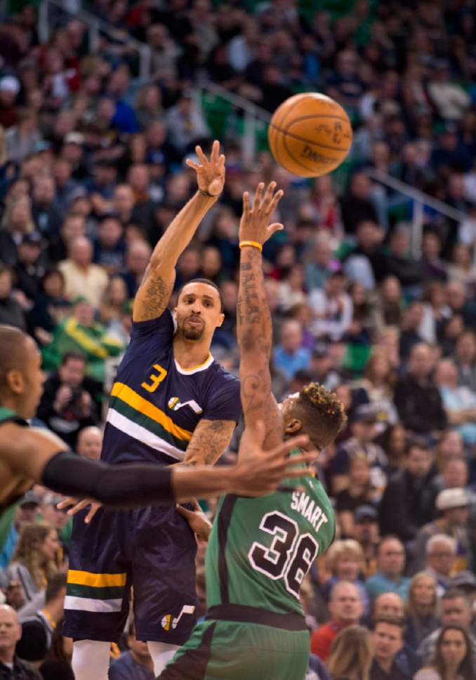 Lennie Mahler  |  The Salt Lake Tribune

George Hill passes over Boston's Marcus Smart in the first half of a game between the Utah Jazz and the Boston Celtics at Vivint Smart Home Arena on Saturday, Feb. 11, 2017.