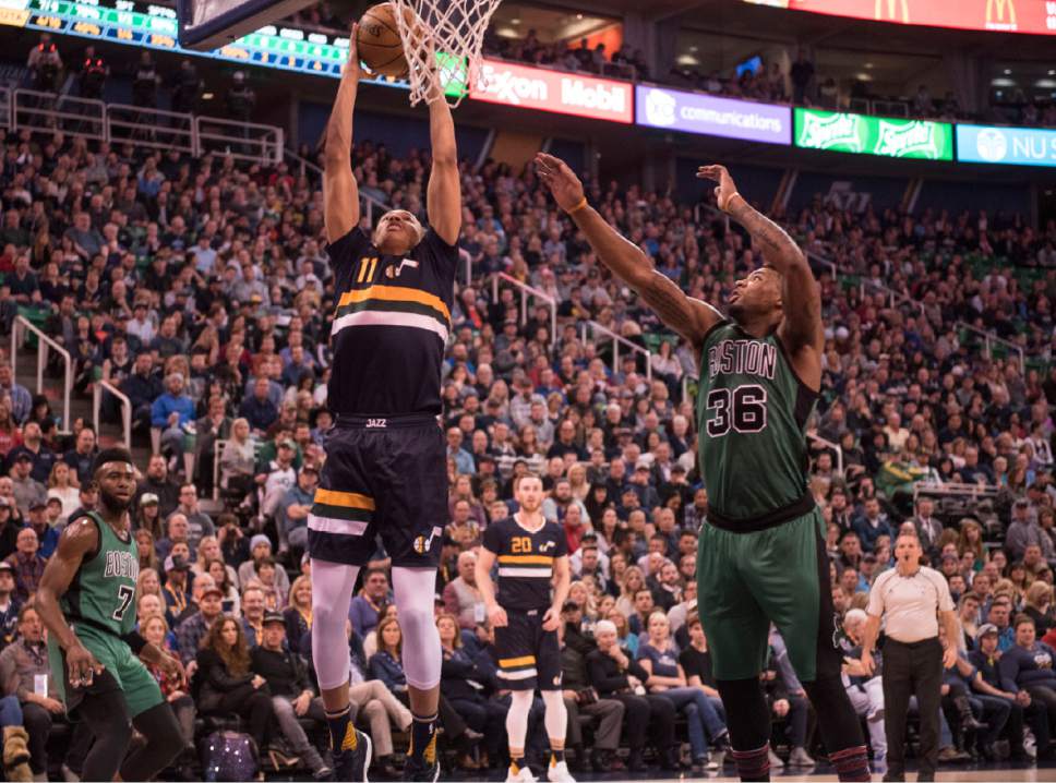 Lennie Mahler  |  The Salt Lake Tribune

Dante Exum dunks the ball over Boston's Marcus Smart in the first half of a game between the Utah Jazz and the Boston Celtics on Saturday, Feb. 11, 2017.