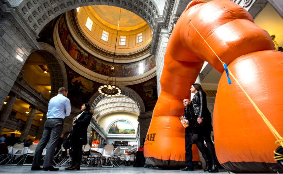 Steve Griffin  |  The Salt Lake Tribune
People walk through an inflatable Delicate Arch as they attend Tourism Day in the Rotunda of the State Capitol in Salt Lake City Monday February 13, 2017