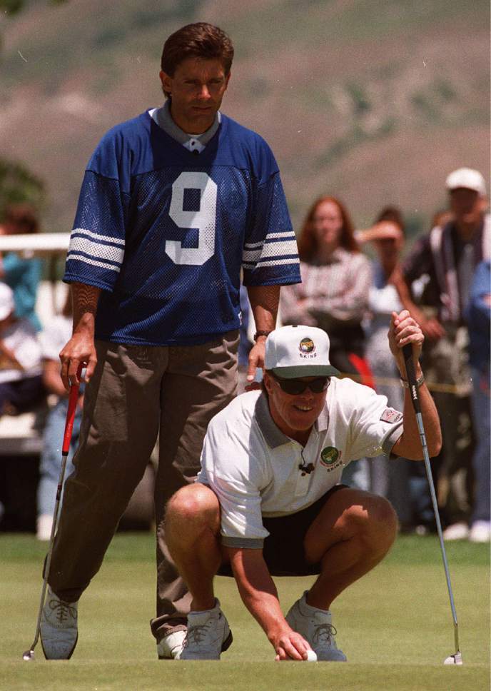 Rick Egan  |  The Salt Lake Tribune

Keith Clearwater helps Jim McMahon line up a putt during the 1997 BYU Skins game.