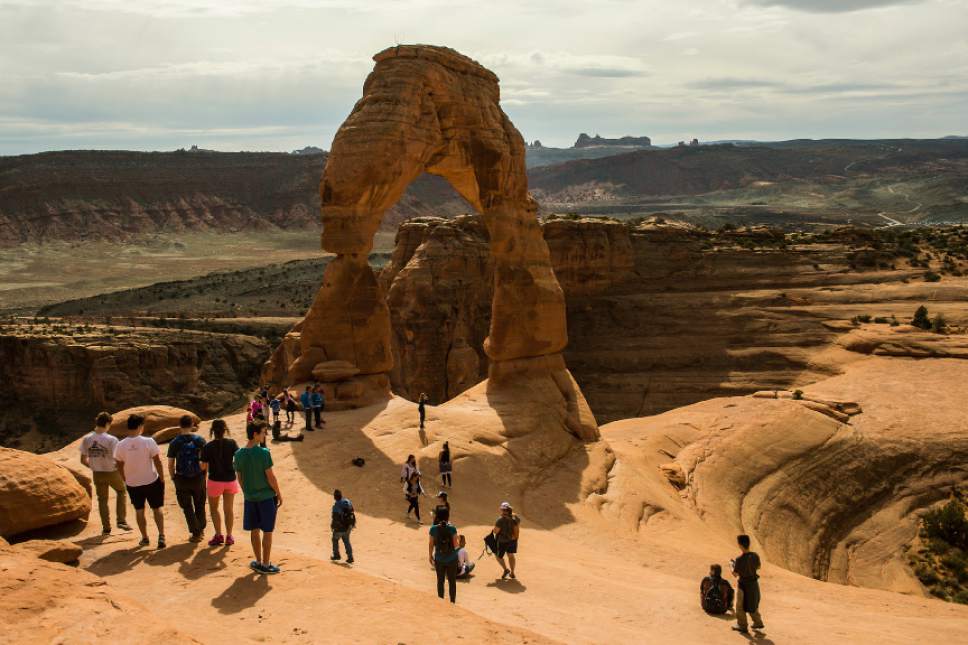 Chris Detrick  |  Tribune file photo
Visitors take pictures and hike around Delicate Arch in Arches National Park Saturday March 5, 2016.  Road construction starting in March and running through November will close key park access roads from 7 p.m. to 7 a.m. except for Friday and Saturday nights.