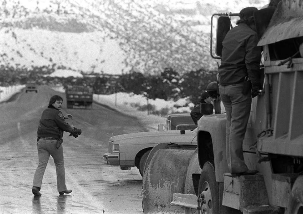 Al Hartmann  |  The Salt Lake Tribune
Emery County Sheriff's deputies monitor the road leading from Orangeville  to the Wilberg Mine as an Emery Mining security man talks to the driver of a truck bringing supplies to support the unsuccessful effort to rescue 27 coal miners trapped by an inferno that erupted on Dec. 19, 1984.
