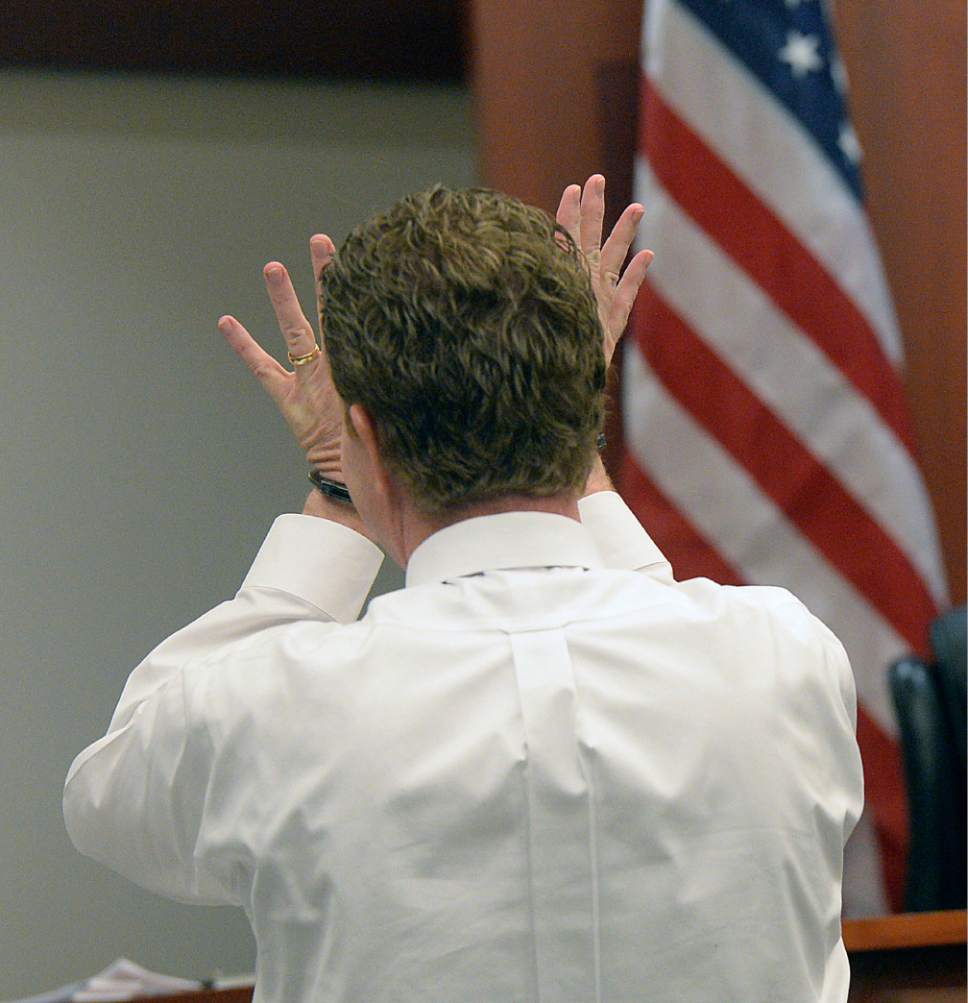 Al Hartmann  |  The Salt Lake Tribune
Jeremy Johnson enters court in Salt Lake City Wednesday Feb. 16.  He had to raise both hands to be sworn in because he had handcuffs on.  He plead the 5th amendment and declined to testify in John Swallow's public corruption traial in Salt Lake City Wed. Feb. 15. He was placed in contempt of court.