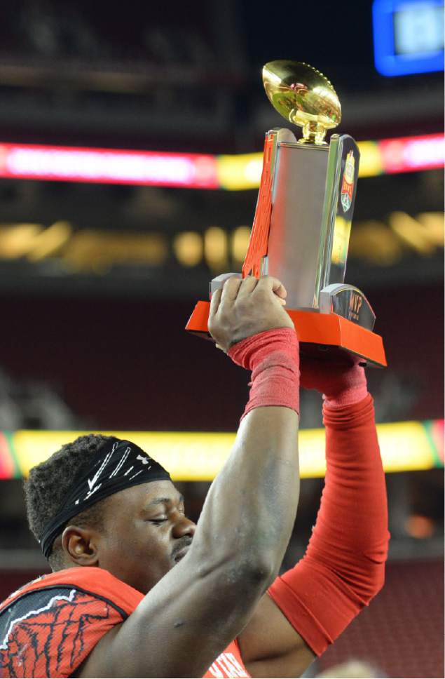 Steve Griffin / The Salt Lake Tribune

Utah Utes running back Joe Williams (28) holds up the offensive player of the game trophy after he rushed for a bowl record during the Foster Farms Bowl at Levi's Stadium in Santa Clara California  Wednesday December 28, 2016.