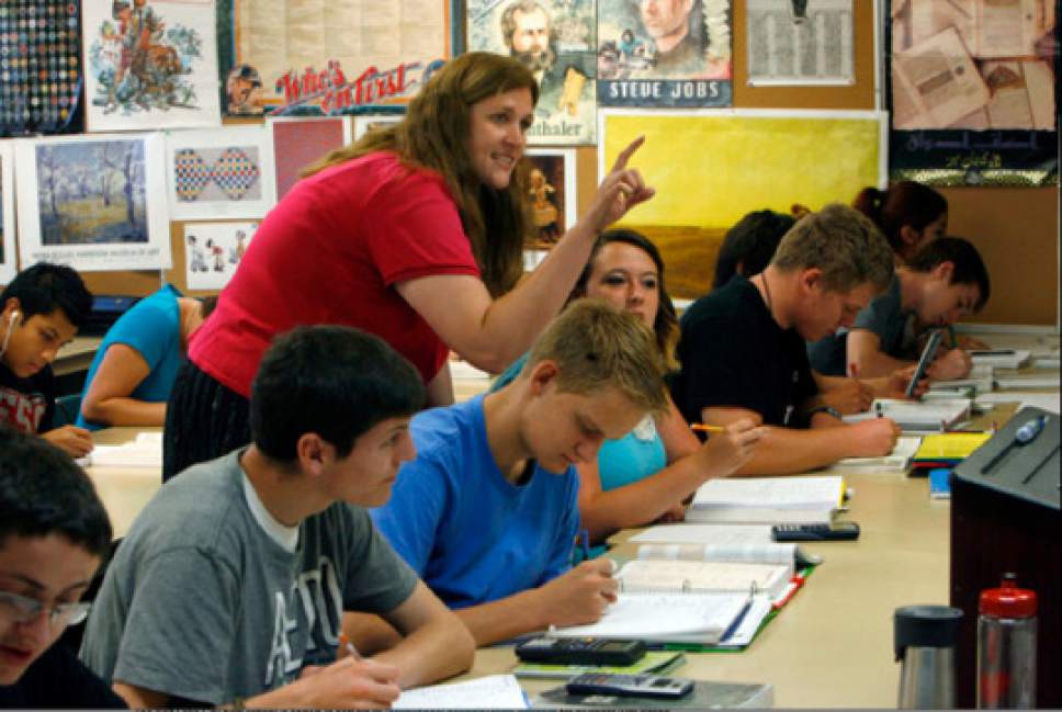 Francisco Kjolseth  |  Tribune file photo
Intro to algebra teacher Jennilyn Derbidge helps a student with an assignment in her Math 1010 class at the Utah County Academy of Sciences school in this file image. UCAS maintained its A grade from last year in the new school letter grades  released Monday.  UCAS is a public early college STEM (Science, Tech, Engineering & Math) charter school located on the UVU campus in Orem.