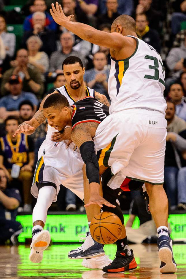 Trent Nelson  |  The Salt Lake Tribune
Portland Trail Blazers guard Damian Lillard (0) is double-teamed by Utah Jazz guard George Hill (3) and center Boris Diaw (33) as the Utah Jazz host the Portland Trailblazers, NBA basketball in Salt Lake City, Wednesday February 15, 2017.