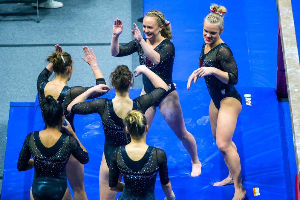 Chris Detrick  |  The Salt Lake Tribune
Utah gymnast Maddy Stover celebrates with her teammates after performing on the beam during the Red Rocks Preview at the Huntsman Center Friday December 11, 2015.