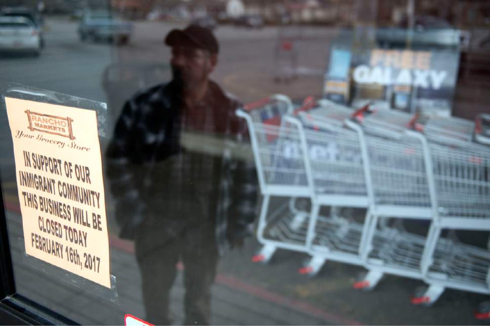 Lennie Mahler  |  The Salt Lake Tribune
A customer who asked not to be identified reads a sign at Rancho Markets in Salt Lake City, one of many businesses in Utah and around the country that closed Thursday for the "A Day Without Immigrants" strike to support immigrants and emphasize their contributions to workplaces and society.