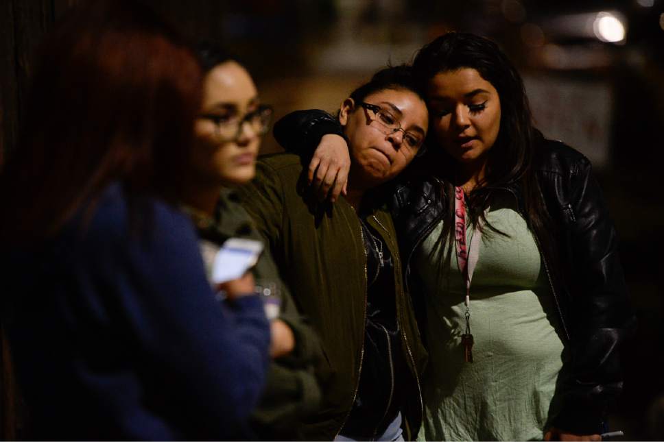 Francisco Kjolseth | The Salt Lake Tribune
West High students Mariana Lopez, center, is embraced by Jasmin Maestas, both 17, as they gather for a candlelight vigil at the scene of a deadly car accident involving students from the school early Thursday morning. Two West High School seniors were killed and two others - another student and a pregnant woman were seriously injured in the head-on collision north of the school.
