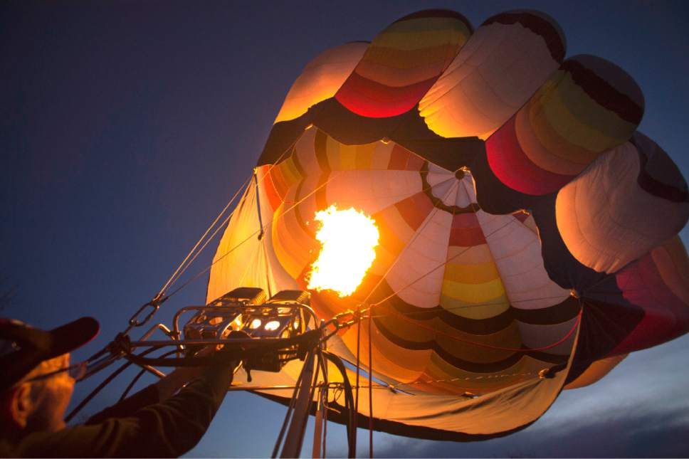 Rick Egan  |  The Salt Lake Tribune

Tom Gough, Twin Falls Idaho inflates "Aire Marc Too,"  for the Glow-in during the Bluff Balloon Festival, Saturday, January 14, 2017.