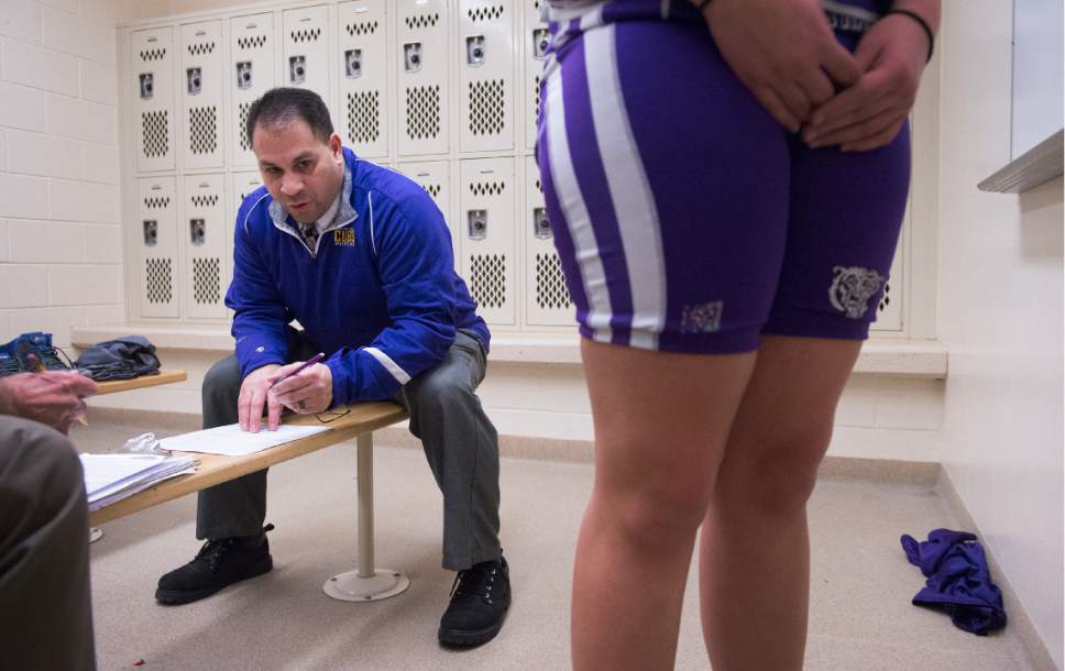 Leah Hogsten  |  The Salt Lake Tribune
Central Davis Junior High wrestling coach Michael Rivera checks the weight of wrestler Kathleen Janis, 15, before her match February 14, 2017 with Mueller Park Junior High. Janis wrestles at 175lbs.. Janis' family has sued the Davis County School District to allow her to wrestle for her school and a judge has temporarily ruled in her favor, allowing her to  compete with the team.