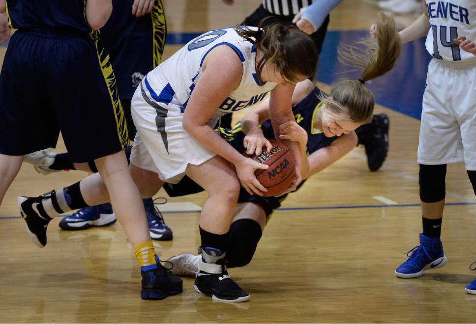 Scott Sommerdorf   |  The Salt Lake Tribune  
Beaver's Nixan Davis, left, and Summit Academy's Amber Romm are locked in a battle for a loose ball during first half play. Beaver beat Summit Academy 57-33, in a Class 2A girls' basketball playoff game played at Orem High, Friday, February 17, 2017.