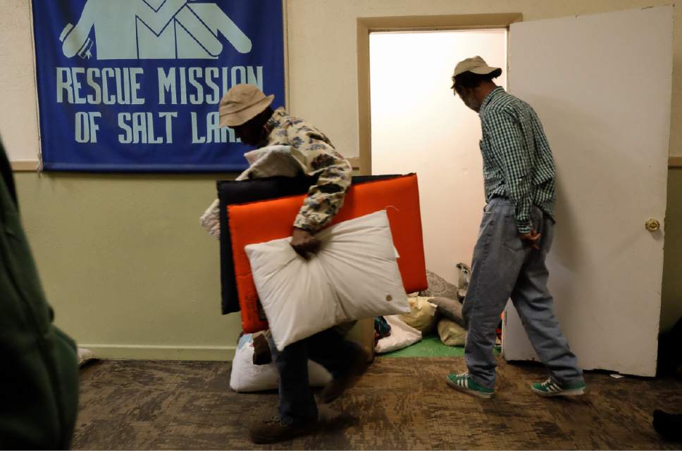 Francisco Kjolseth | The Salt Lake Tribune
Homeless men take turns picking out sleeping pads, pillows and blankets to lay down on the floor of chapel at the Rescue Mission in Salt Lake following nightly services on Thursday, Feb. 2, 2017. With only 56 beds upstairs, frequently another 60 or more crowd into the chapel in order to stay off the streets for the night.