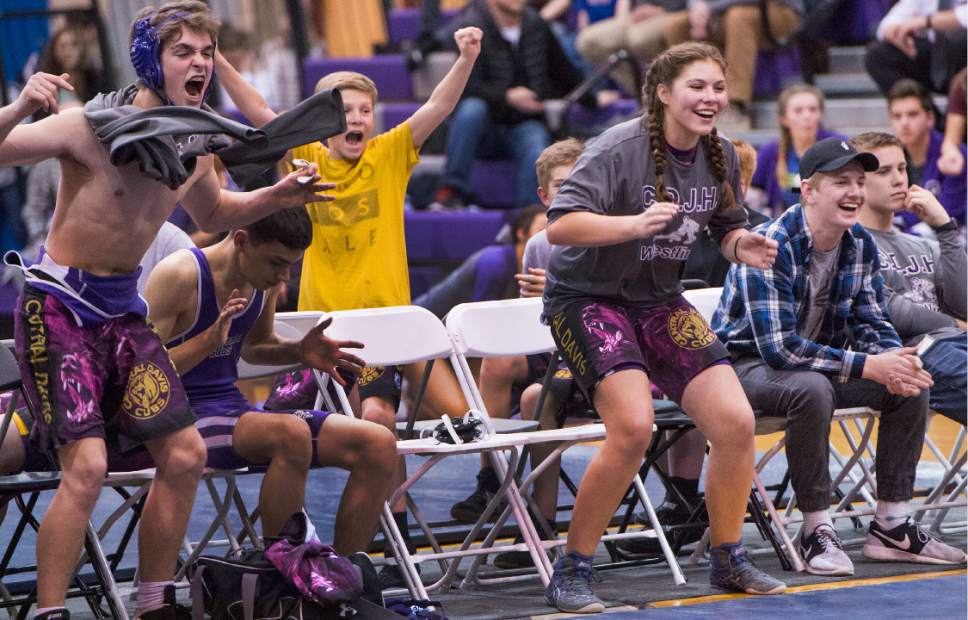 Leah Hogsten  |  The Salt Lake Tribune
Central Davis Junior High wrestling athlete Kathleen Janis, 15, cheers her teammate Gabi Serrao, 14, during Gabi's match February 14, 2017 with a wrestler from Mueller Park Junior High. Janis' family has sued the Davis County School District to allow her to wrestle for her school and a judge has temporarily ruled in her favor, allowing her to  compete with the team.