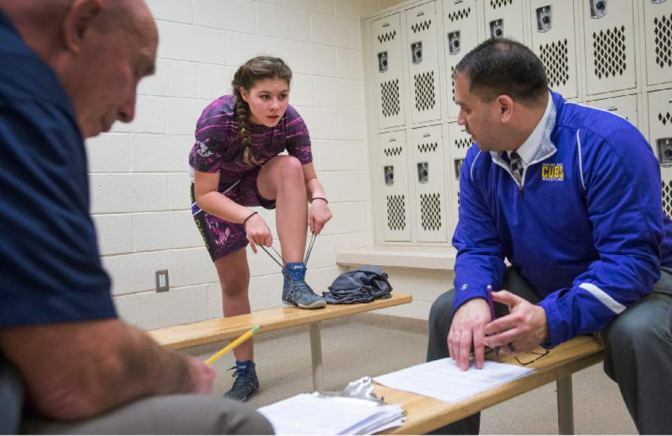 Leah Hogsten  |  The Salt Lake Tribune
Central Davis Junior High wrestling athlete Kathleen Janis, 15, takes off her shoes before getting weighed for a match February 14, 2017 with Mueller Park Junior High. Janis wrestles at 175lbs.. Janis' family has sued the Davis County School District to allow her to wrestle for her school and a judge has temporarily ruled in her favor, allowing her to  compete with the team.