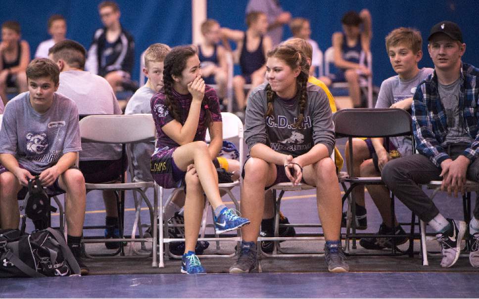 Leah Hogsten  |  The Salt Lake Tribune
l-r Central Davis Junior High wrestlers Gabi Serrao, 14, and Kathleen Janis, 15, share a laugh February 14, 2017 during their match against Mueller Park Junior High. Janis' family has sued the Davis County School District to allow her to wrestle for her school and a judge has temporarily ruled in her favor, allowing her to  compete with the team.