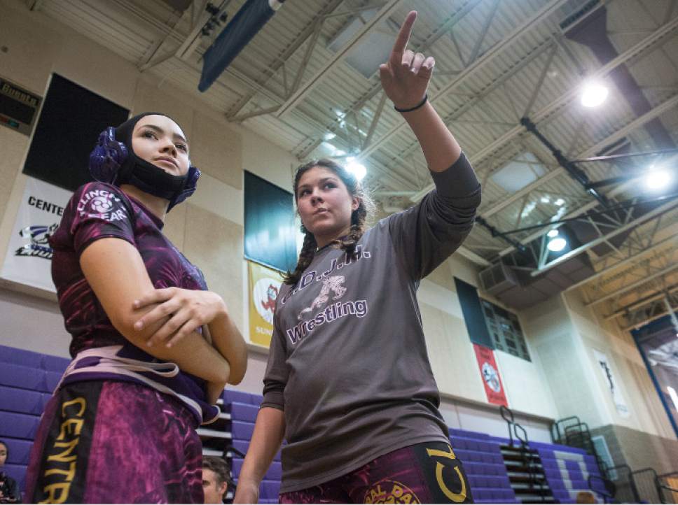 Leah Hogsten  |  The Salt Lake Tribune
l-r Central Davis Junior High wrestler Gabi Serrao, 14, gets advice from teammate Kathleen Janis, 15, before hitting the mat February 14, 2017 against her Mueller Park Junior High opponent. Janis' family has sued the Davis County School District to allow her to wrestle for her school and a judge has temporarily ruled in her favor, allowing her to  compete with the team.