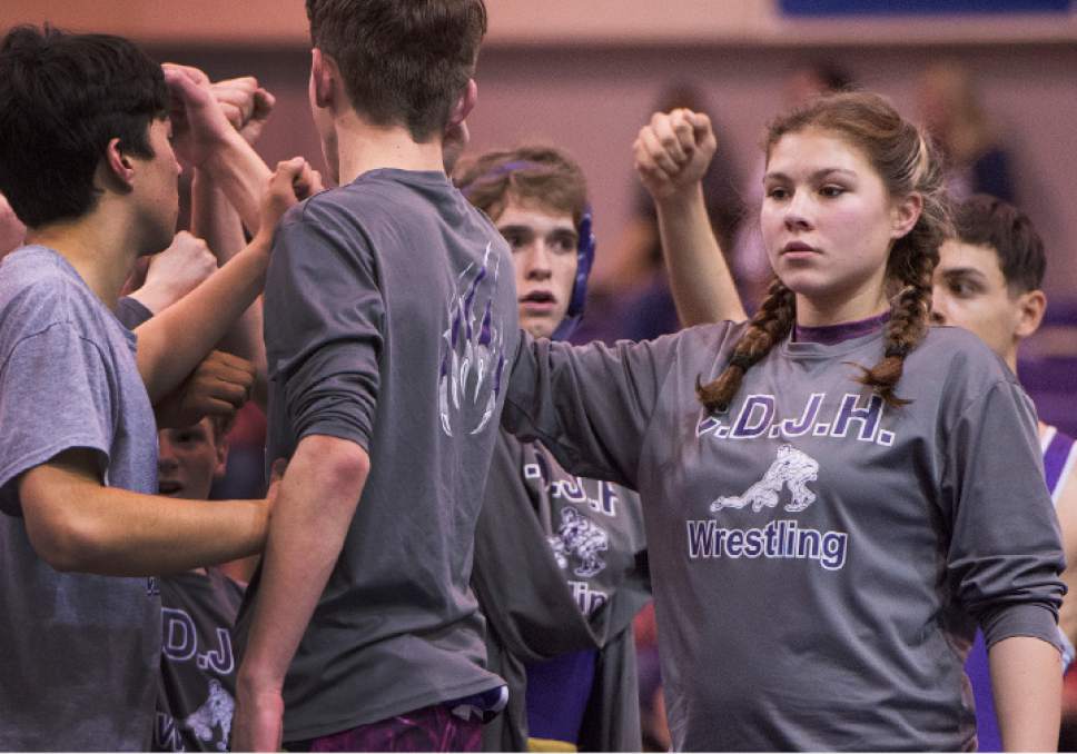 Leah Hogsten  |  The Salt Lake Tribune
Central Davis Junior High wrestling athlete Kathleen Janis, 15, cheers her teammates during their match February 14, 2017 with Mueller Park Junior High. Janis' family has sued the Davis County School District to allow her to wrestle for her school and a judge has temporarily ruled in her favor, allowing her to  compete with the team.