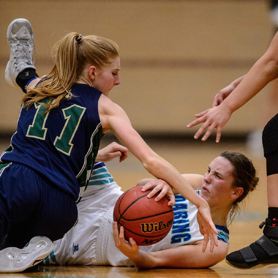 Trent Nelson  |  The Salt Lake Tribune
Juan Diego's Brynn Drummond holds the ball as Snow Canyon's Hallie Remund reaches in as Juan Diego hosts Snow Canyon in a 3A playoff game, girls' high school basketball in Draper, Saturday February 18, 2017.