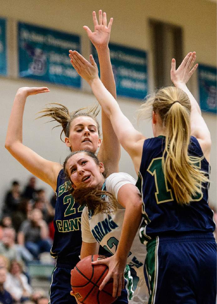 Trent Nelson  |  The Salt Lake Tribune
Juan Diego's Trista Vawdrey, defended by Snow Canyon's Allie Parr and Snow Canyon's Alivia Hinton  as Juan Diego hosts Snow Canyon in a 3A playoff game, girls' high school basketball in Draper, Saturday February 18, 2017.