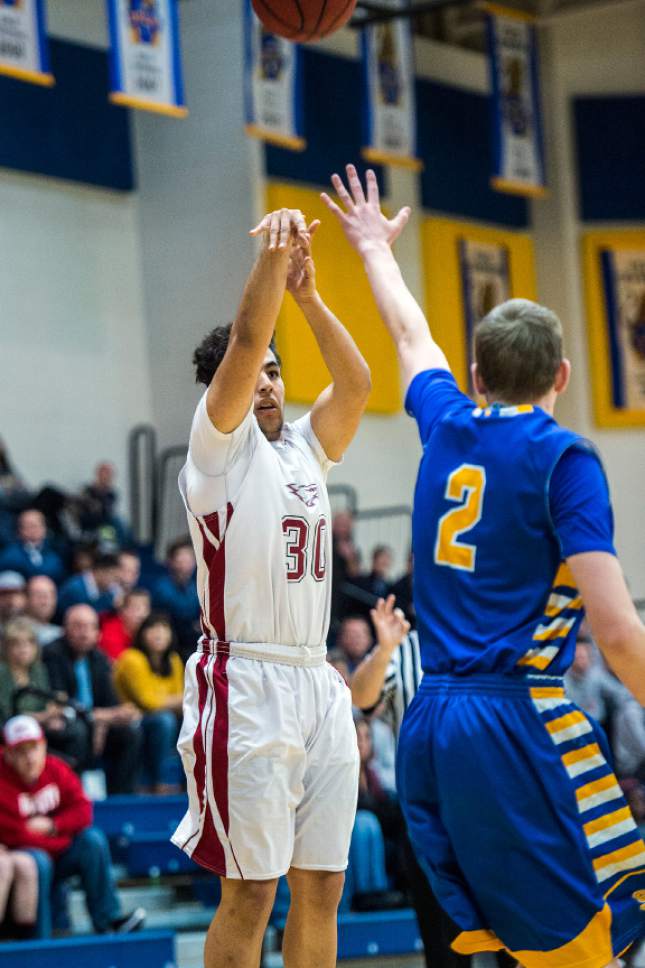 Chris Detrick  |  The Salt Lake Tribune
Layton Christian Oscar Lopez (30) shoots past San Juan Landen Pemberton (2) during the 2A play-off game at Orem High School Saturday February 18, 2017. Layton Christian defeated San Juan 81-63.