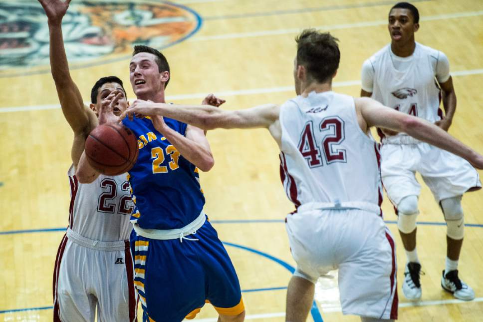 Chris Detrick  |  The Salt Lake Tribune
Layton Christian Chan Hargraves (42) and Layton Christian Christians Gutierrez (22) guard San Juan Jordan Blake (23) during the 2A play-off game at Orem High School Saturday February 18, 2017. Layton Christian defeated San Juan 81-63.