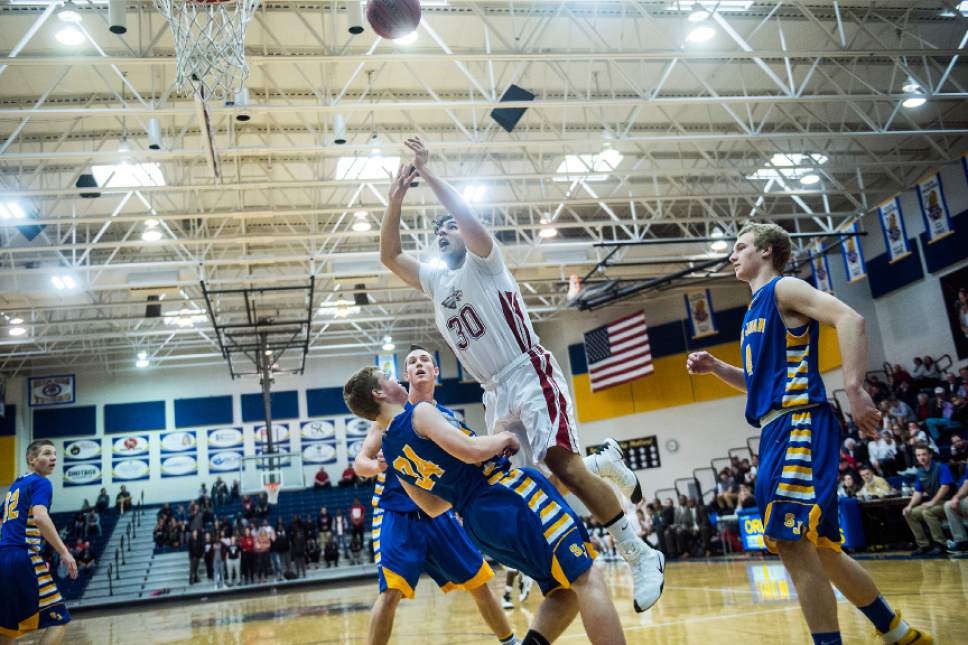 Chris Detrick  |  The Salt Lake Tribune
Layton Christian Oscar Lopez (30) shoots over San Juan Seth Pugh (34) during the 2A play-off game at Orem High School Saturday February 18, 2017. Layton Christian defeated San Juan 81-63.