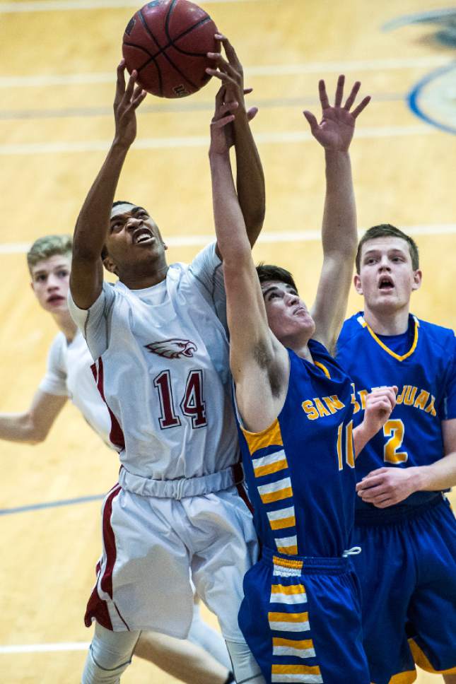 Chris Detrick  |  The Salt Lake Tribune
Layton Christian Micah Petty (14) and San Juan Lyle Palmer (10) go for a rebound during the 2A play-off game at Orem High School Saturday February 18, 2017. Layton Christian defeated San Juan 81-63.