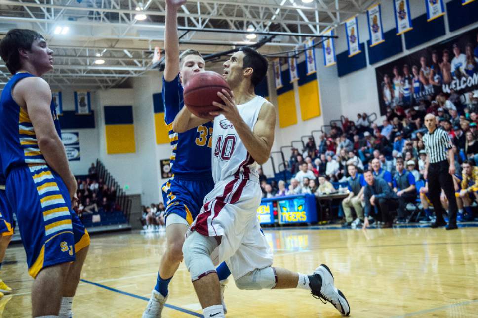 Chris Detrick  |  The Salt Lake Tribune
Layton Christian Ben Cerda (40) is guarded by San Juan Ramsay Holliday (32) and San Juan Dylan Ivins (3) during the 2A play-off game at Orem High School Saturday February 18, 2017. Layton Christian defeated San Juan 81-63.