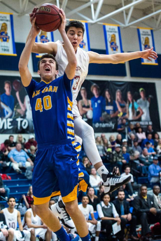 Chris Detrick  |  The Salt Lake Tribune
Layton Christian Nicolas Aguirre (23) fouls San Juan Jaden Torgerson (40) during the 2A play-off game at Orem High School Saturday February 18, 2017. Layton Christian defeated San Juan 81-63.