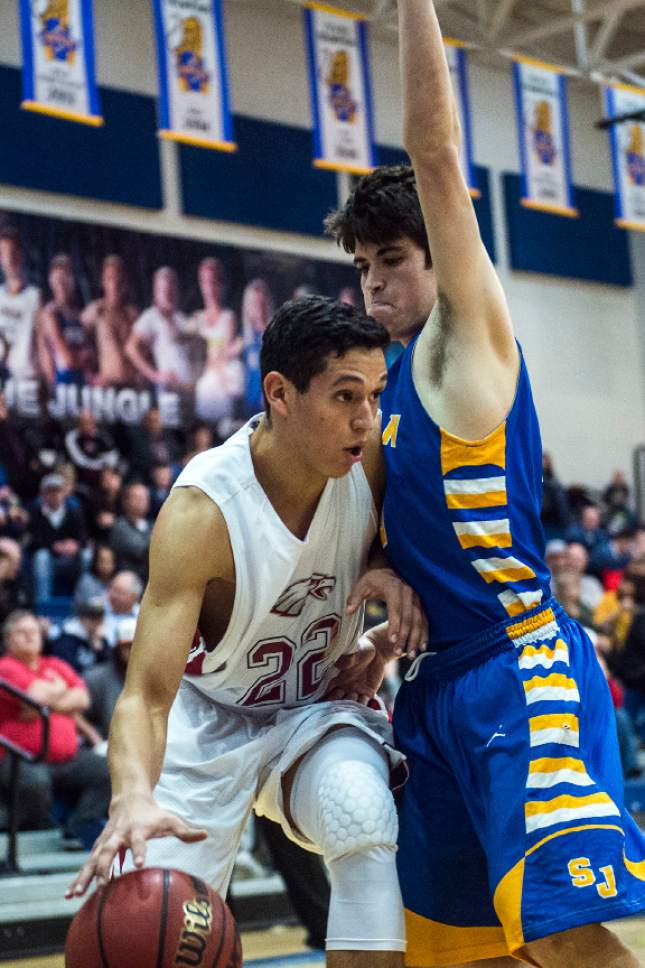 Chris Detrick  |  The Salt Lake Tribune
Layton Christian Christians Gutierrez (22) runs past San Juan Lyle Palmer (10) during the 2A play-off game at Orem High School Saturday February 18, 2017. Layton Christian defeated San Juan 81-63.