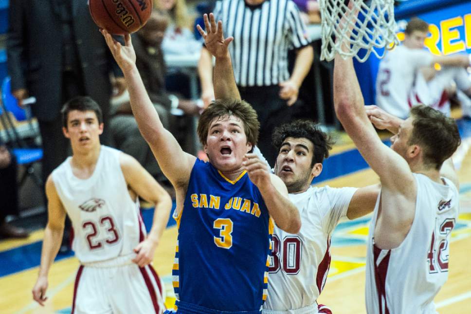 Chris Detrick  |  The Salt Lake Tribune
San Juan Dylan Ivins (3) shoots past Layton Christian Oscar Lopez (30) and Layton Christian Chan Hargraves (42) during the 2A play-off game at Orem High School Saturday February 18, 2017. Layton Christian defeated San Juan 81-63.