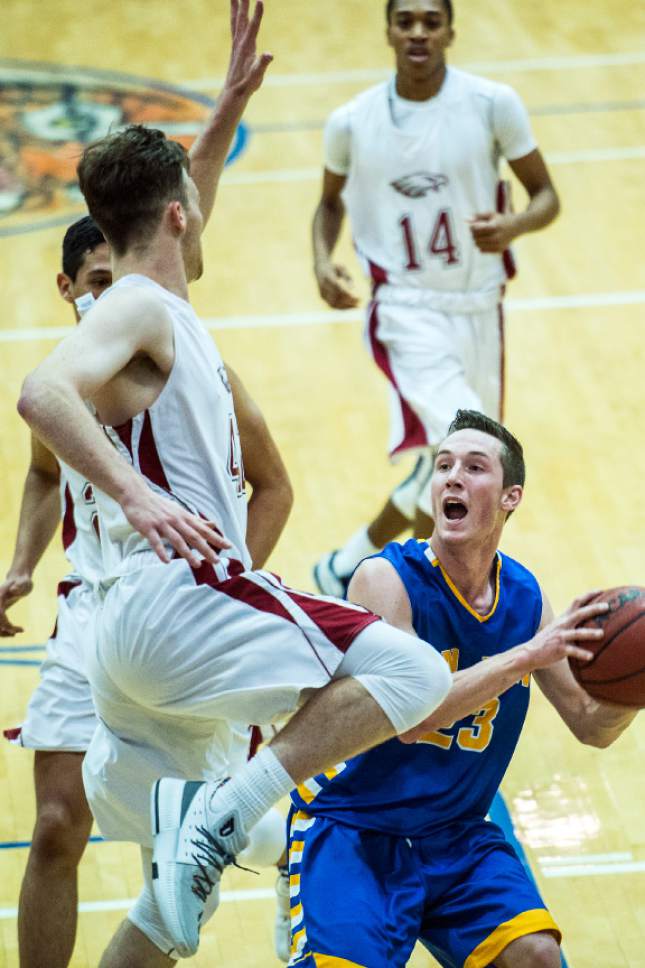 Chris Detrick  |  The Salt Lake Tribune
Layton Christian Chan Hargraves (42) blocks San Juan Jordan Blake (23) during the 2A play-off game at Orem High School Saturday February 18, 2017. Layton Christian defeated San Juan 81-63.