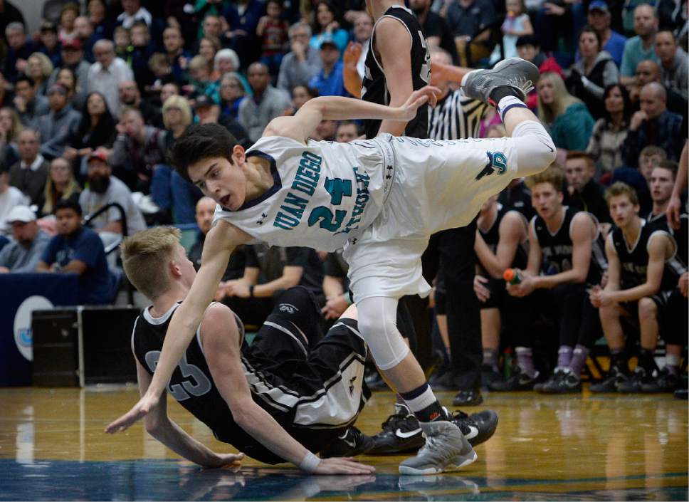 Scott Sommerdorf   |  The Salt Lake Tribune  
Juan Diego's Ignacio Arroyo takes an awkward fall after a drive to the hoop during first half play. Juan Diego defeated Pine View 47-42 in a boys 3A playoff, Friday, February 17, 2017.