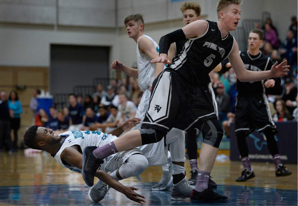 Scott Sommerdorf   |  The Salt Lake Tribune  
Juan Diego's Jason Ricketts has his leg caught under him as he falls awkwardly after defending against Pine View's Trey Farrer during second half play. Juan Diego defeated Pine View 47-42 in a boys 3A playoff, Friday, February 17, 2017.