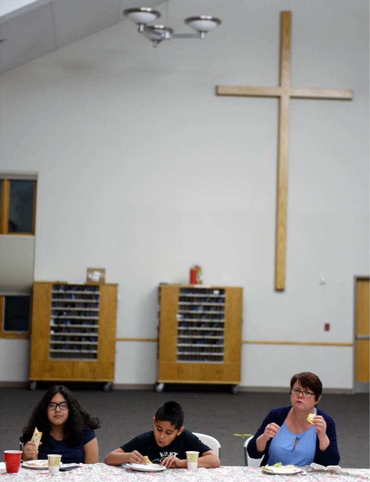 Steve Griffin  |  The Salt Lake Tribune

Teresa Deppe, of Good Shepherd Lutheran Church, eats dinner with Stephanie and Javier Tinajero and their two children, Jessica, 11, and Jak, 9, in the church in Sandy, Utah, Tuesday Jan. 31, 2017. Many area churches are involved with Family Promise in which various churches house up to homeless families at their meetinghouses for a week. Lots of volunteers help provide the meals and help take care of the residents.