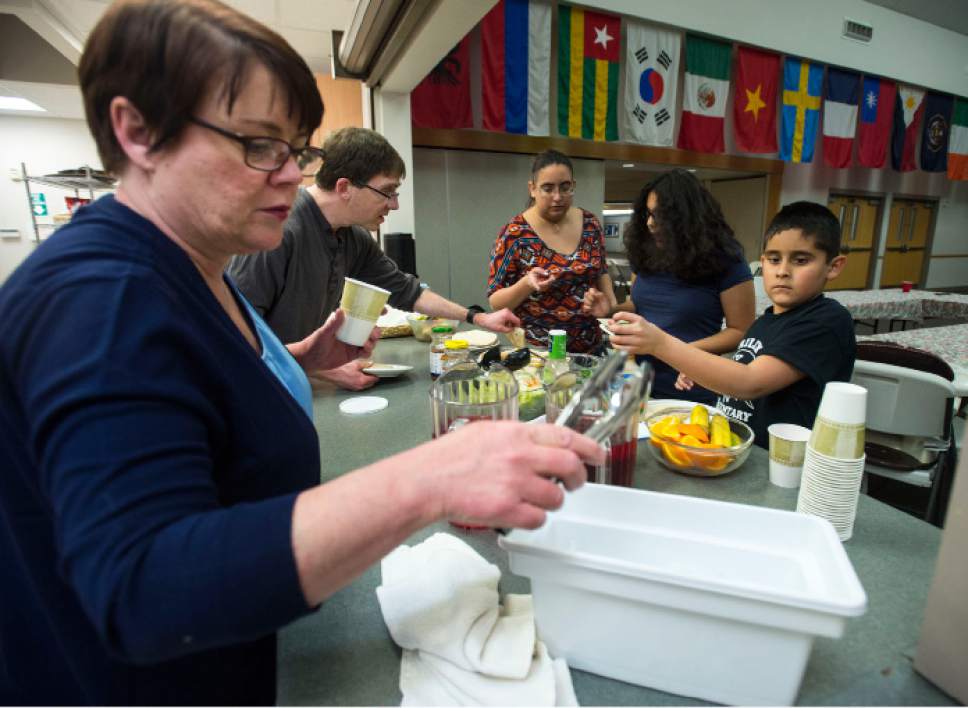 Steve Griffin  |  The Salt Lake Tribune

Teresa Deppe and Erik Knudson, of Good Shepherd Lutheran Church, serve dinner to Stephanie Tinajero and her two children, Jessica, 11, and Jak, 9, in the church in Sandy, Utah, Tuesday Jan. 31, 2017. Many area churches are involved with Family Promise in which various churches house up to homeless families at their meetinghouses for a week. Lots of volunteers help provide the meals and help take care of the residents.