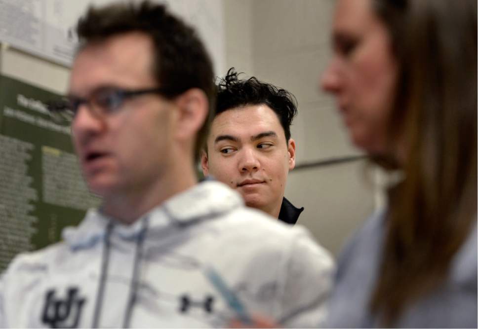 Scott Sommerdorf   |  The Salt Lake Tribune  
Salt Lake Tribune sports writer Kyle Goon peeks at results of a test while Ernie Rimer, left, a PhD student at the U., and grad student Jenn Link, right. Rimer has been hired to be a sports scientist for Utah athletics. Working with football, volleyball and men's basketball, he's introduced data-driven changes into how the Utes train, potentially giving them an edge that they can't otherwise achieve against bigger budgeted programs, Wednesday, February 15, 2017.