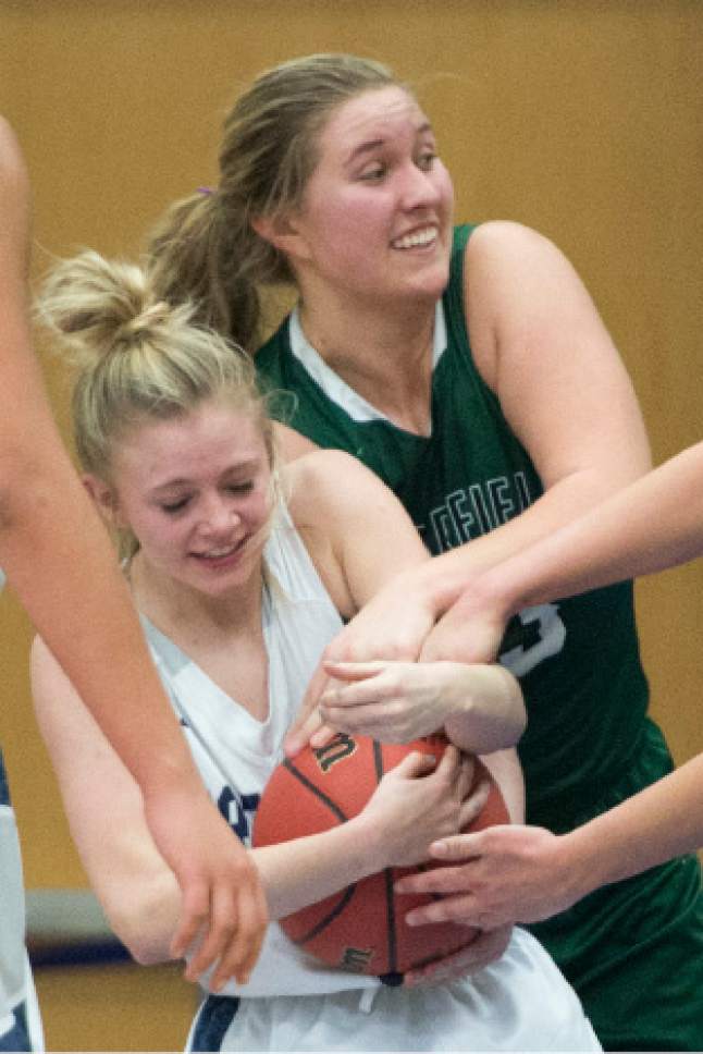 Rick Egan  |  The Salt Lake Tribune

Cailin McGarry (13) ties up Amberly Lazenby (1) Copper Hills, in 5A girls basketball playoff action, Clearfield vs. Copper Hills, Monday, February 20, 2017.