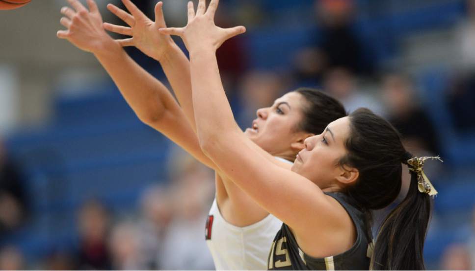 Steve Griffin  |  The Salt Lake Tribune

American Fork's Taylor Moeaki (13), left, and Davis's Malia Tupuola reach for a rebound during second round game  in the girl's 5A basketball state tournament at SLCC in Taylorsville, Wednesday, February 18, 2015.