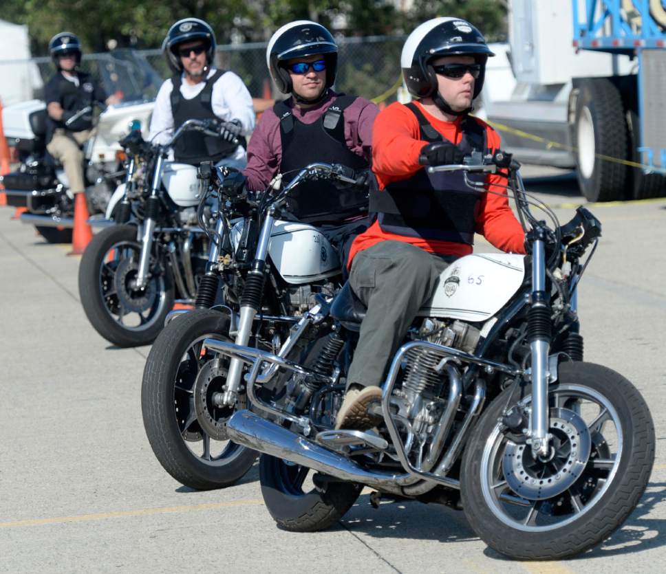 Al Hartmann  |  The Salt Lake Tribune
Officers from four other law enforcement agencies run a slalom course of orange cones to practice control at the Salt Lake City Police Department's annual motor school for officers interested in assignment to the motorcycle squad.  The two week long class trains at the Utah State Fairground.  The purpose of the school is to make certain candidates are able to operate a motorcycle under sceanarios encountered by motor officers on patrol. The riders must prove their skill by navigating a variety of obstacle courses and pass a hard-controlled breaking exam.